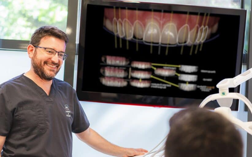 Diseño de sonrisa en la clínica Ferrus & Bratos Aparece un Doctor explicando un diseño de sonrisa a paciente